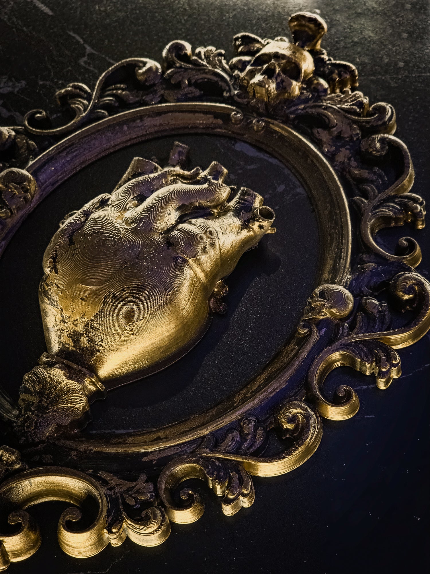 Close-up of the anatomical heart sculpture, showing realistic vein and artery textures against a dark background.