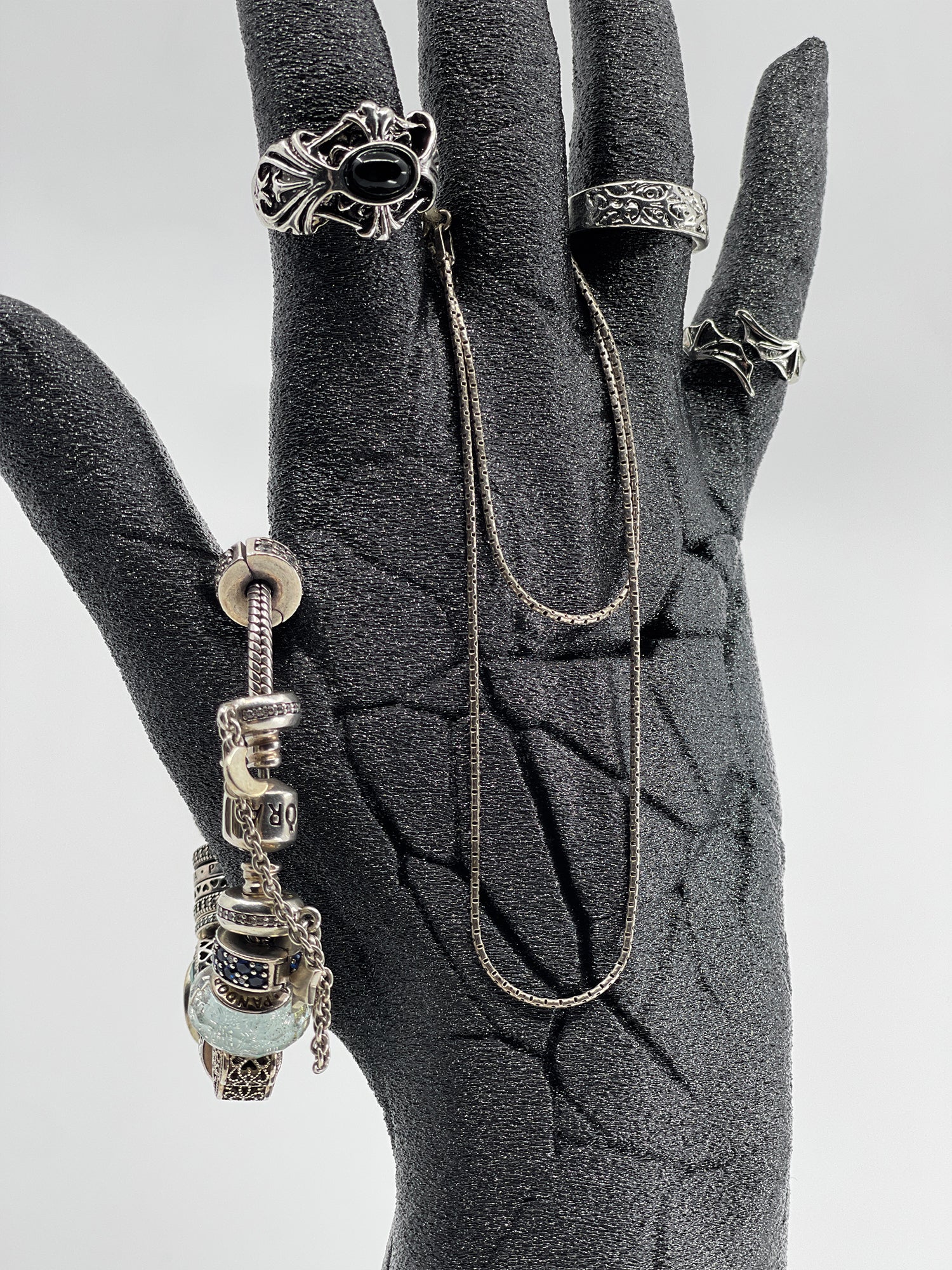 Side profile of the broken hand ring holder showing the detailed anatomical structure and cracked skin effect.