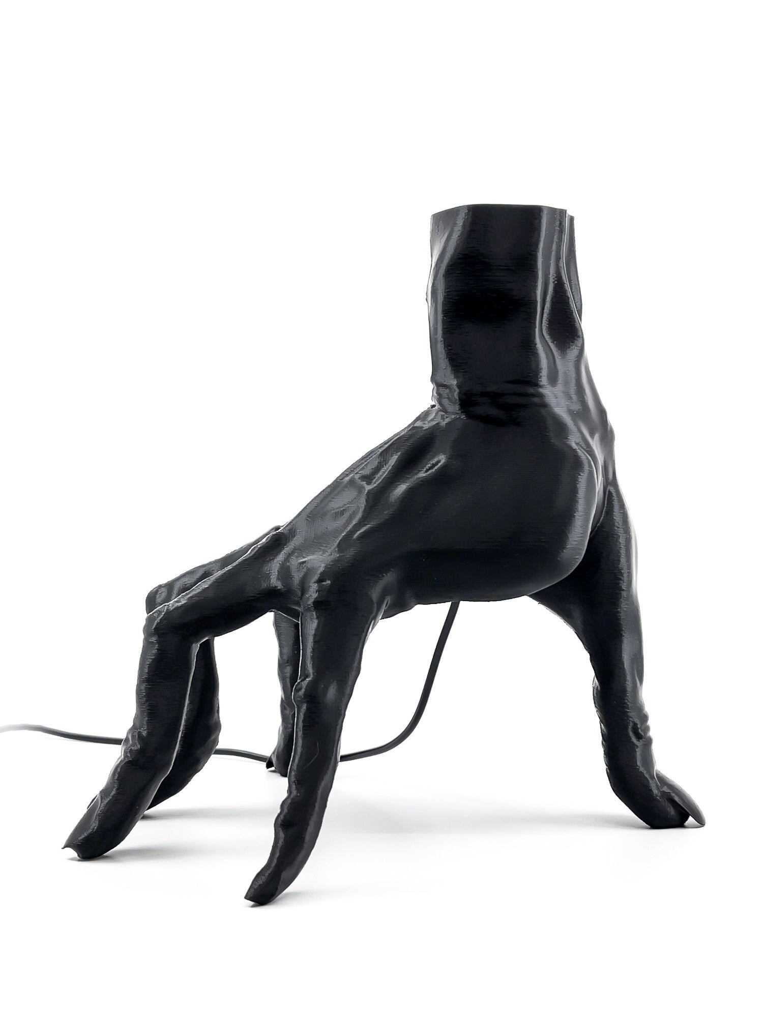 Side profile of the anatomical crawling hand watch stand showing the realistic muscle and tendon detail.