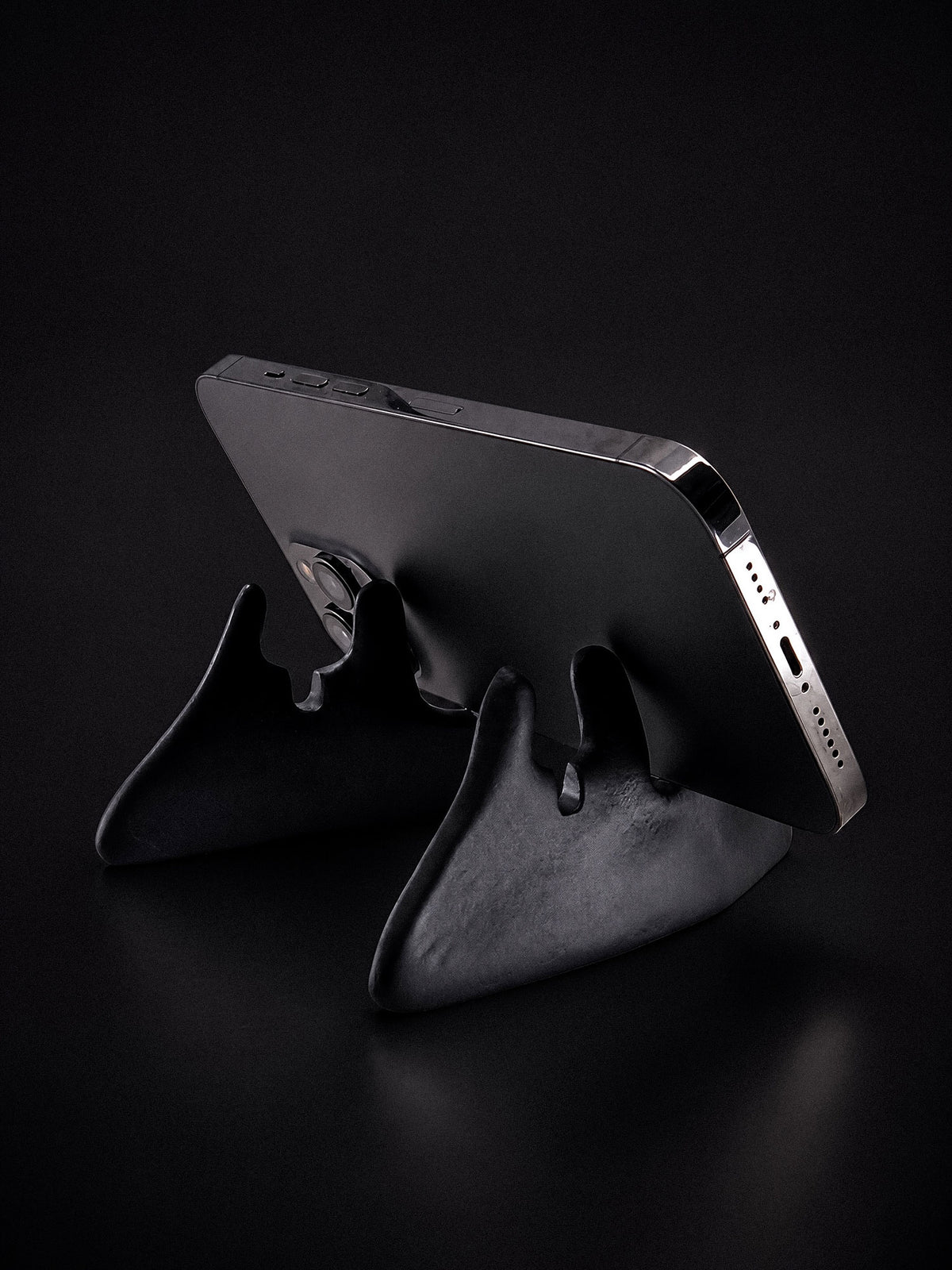 Rear view of Bite black jawbone stand holding a smartphone horizontally.