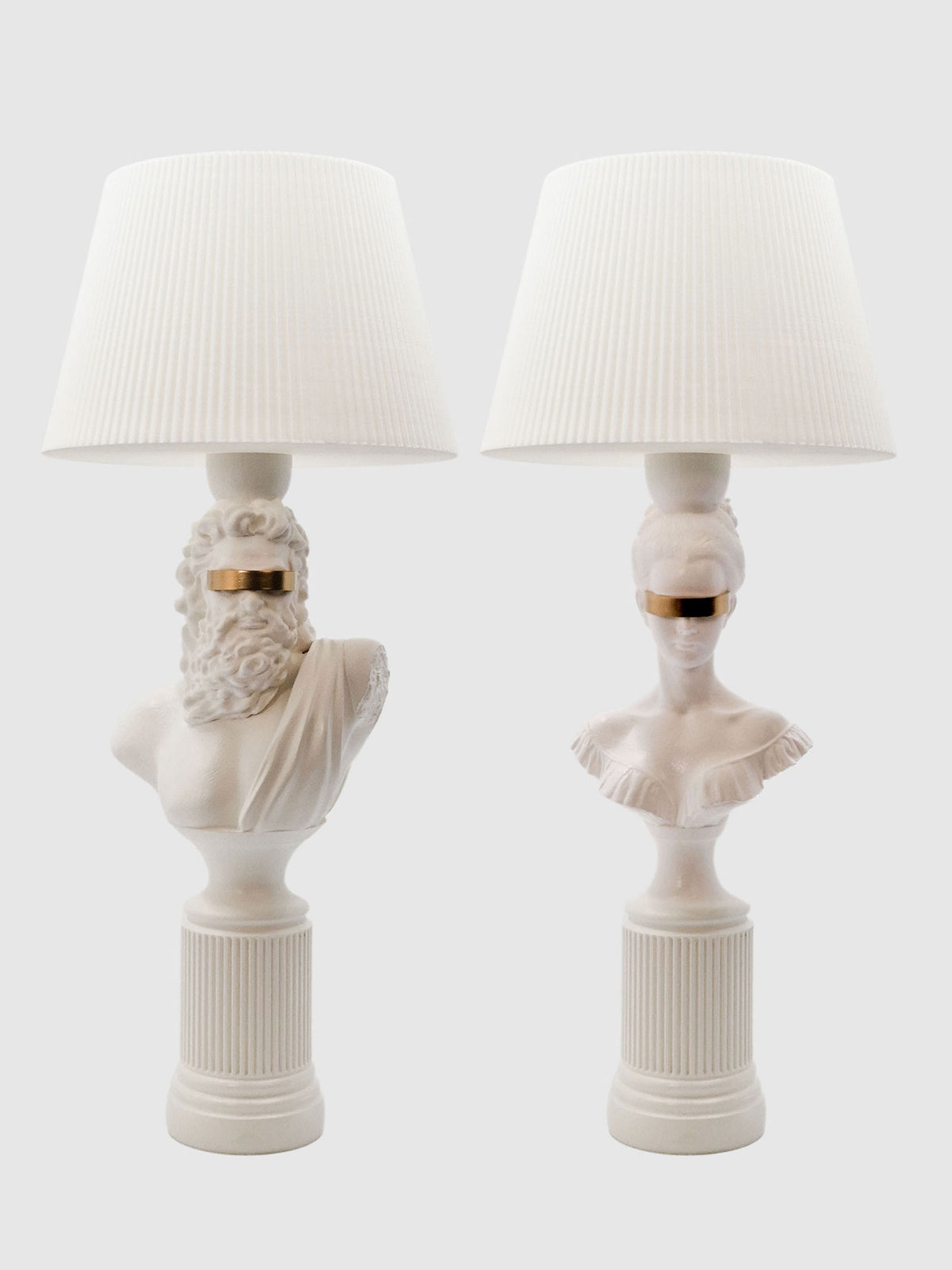 A symmetrical set of Blind Zeus and Hera white and gold classical bust lamps with matching white shades.