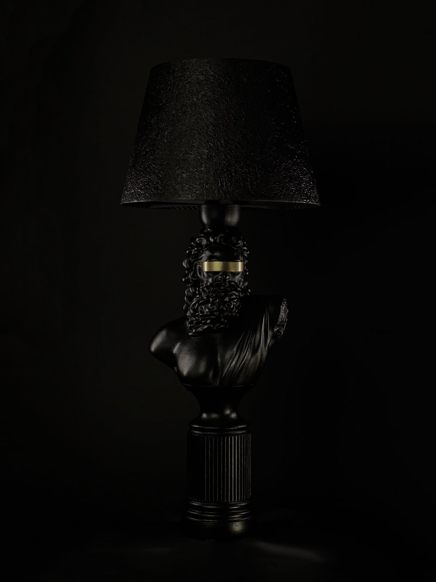 Blind Zeus sculptural lamp in satin black with a gold blindfold and textured black shade