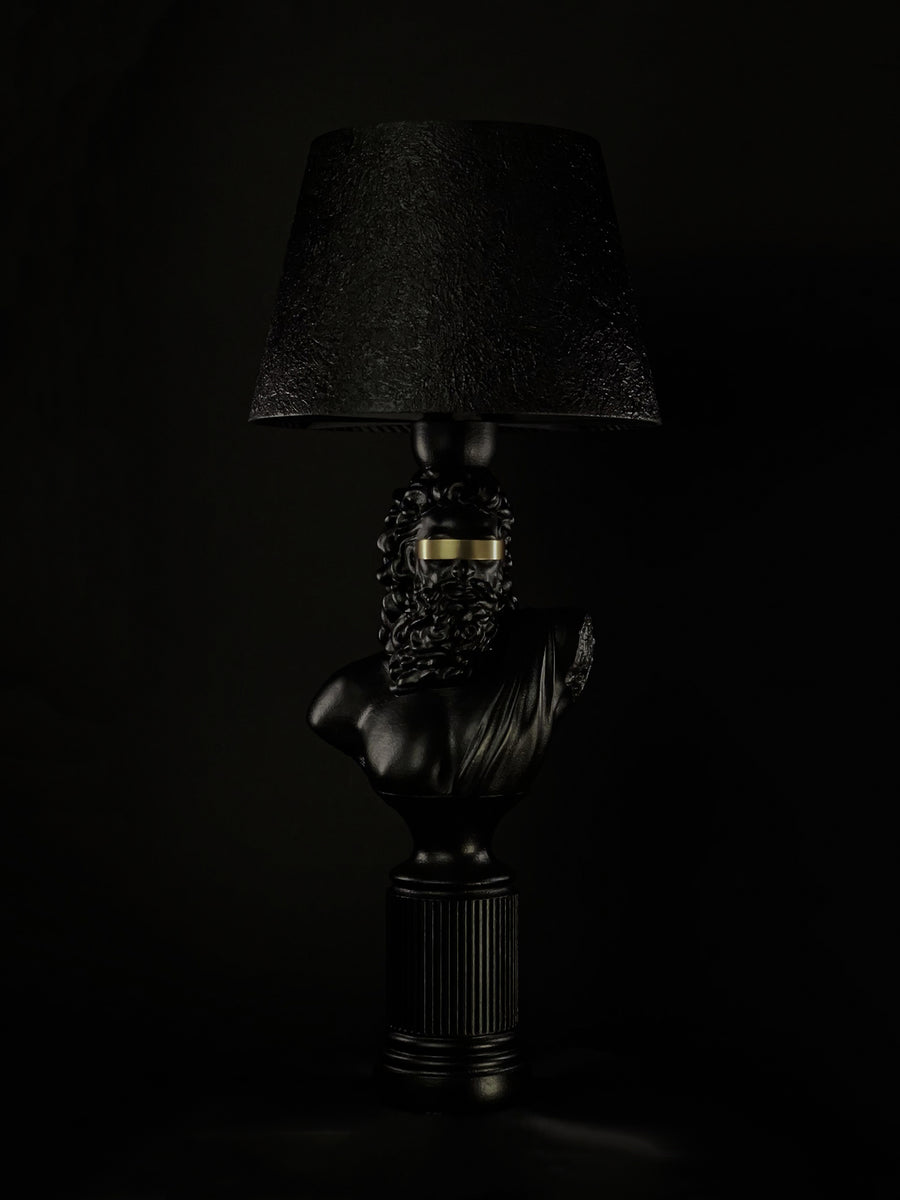 Blind Zeus sculptural lamp in satin black with a gold blindfold and textured black shade