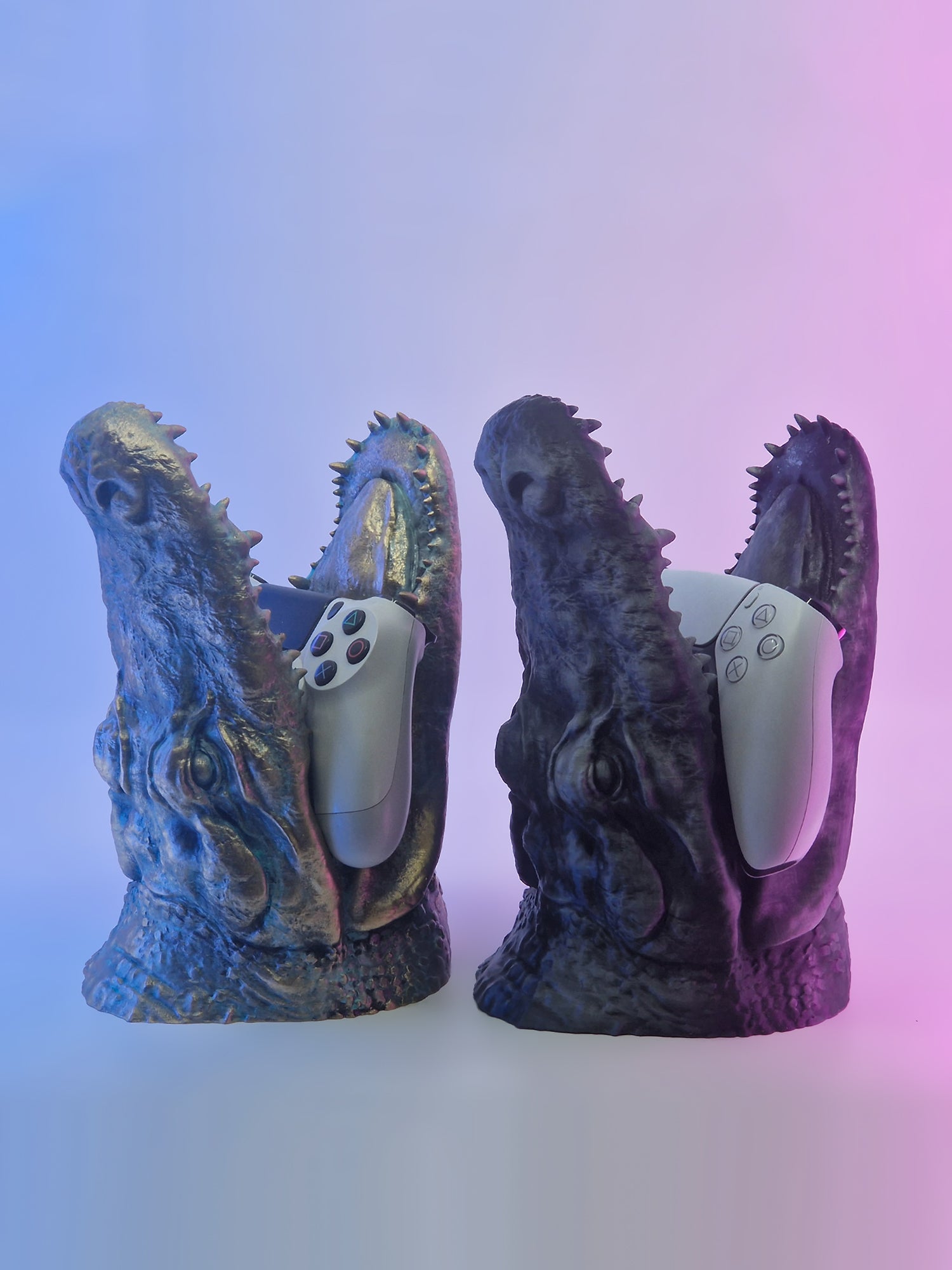 A pair of crocodile jaw controller stands in black and gold patina with purple and blue ambient lighting.