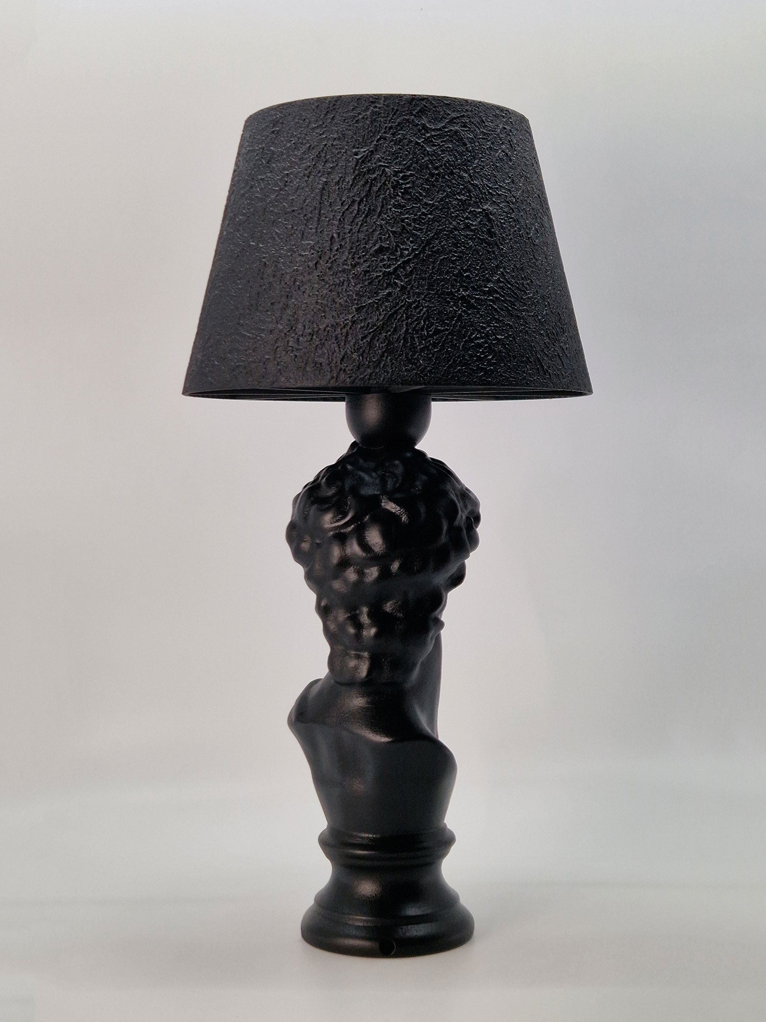 Back view of the David bust lamp showcasing the detailed curls and the elegant pedestal base.