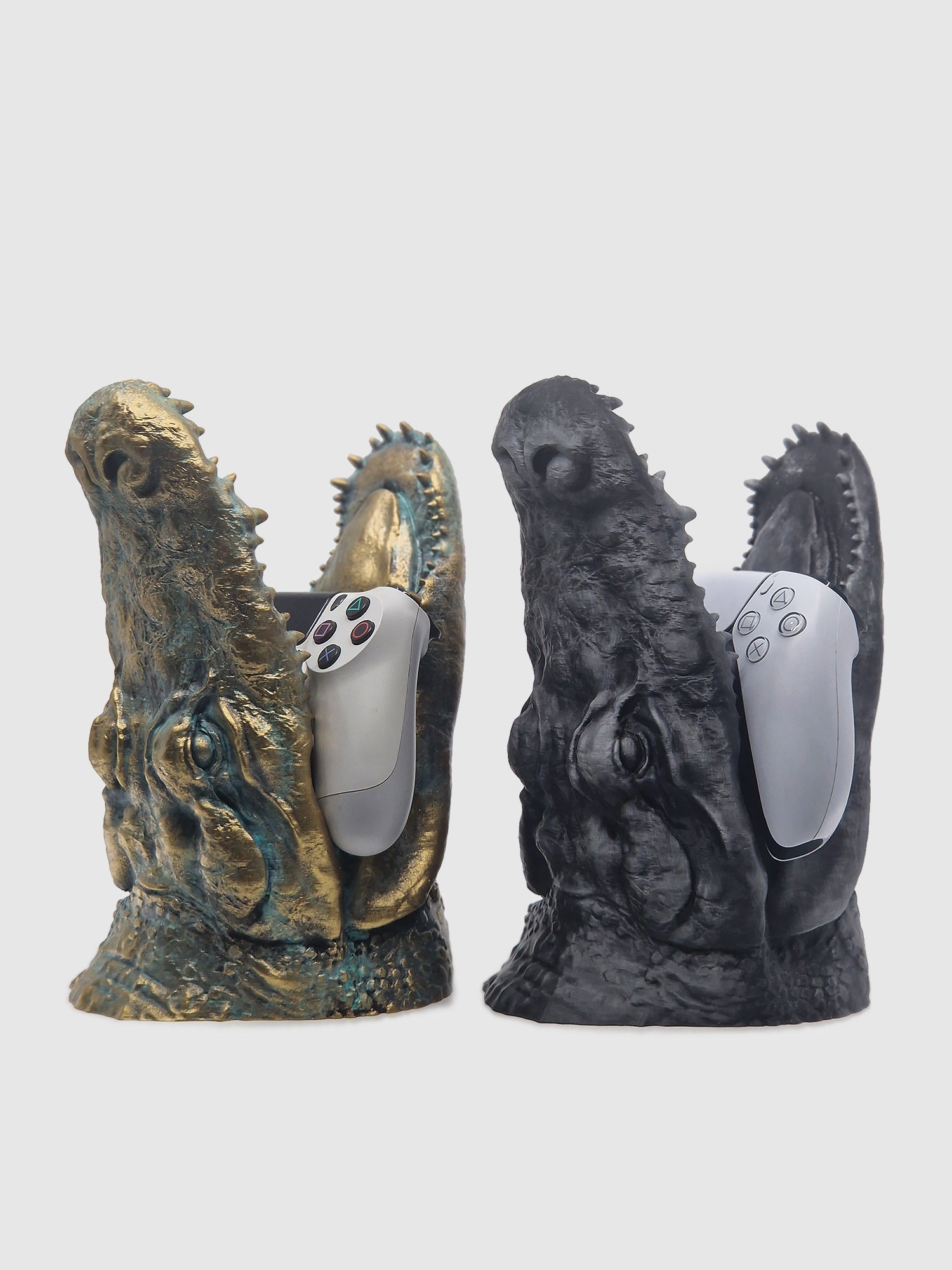 Front view of the Predator Jaw stands in gold and black finishes, showcasing realistic reptilian textures.