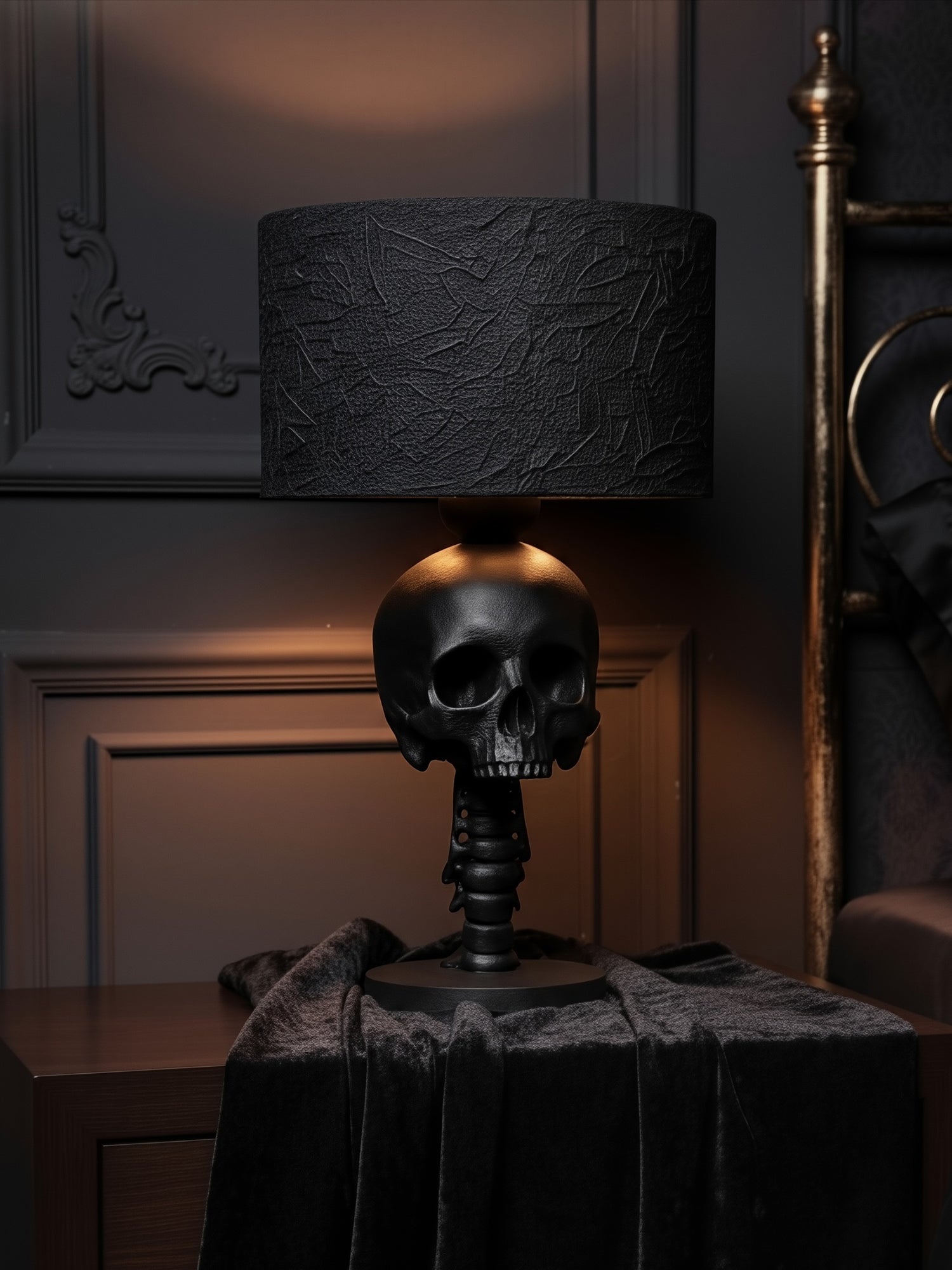 Lifestyle shot of the Skull Spine lamp on a nightstand in a moody, dark academia bedroom with elegant molding.