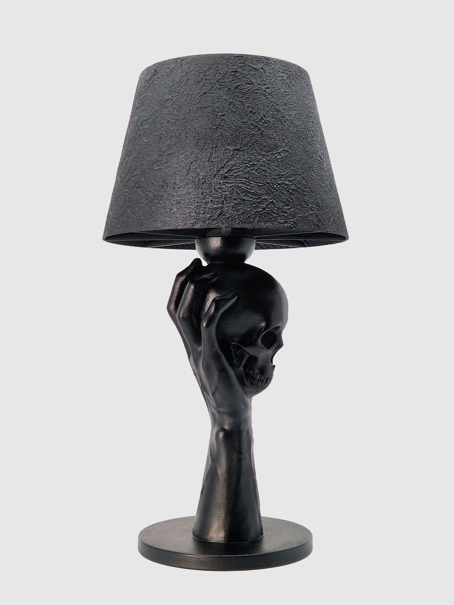 Side profile of the Hamlet-inspired lamp showing the anatomical details of the hand and the skull sculpture, designed and manufactured by Horror Romance