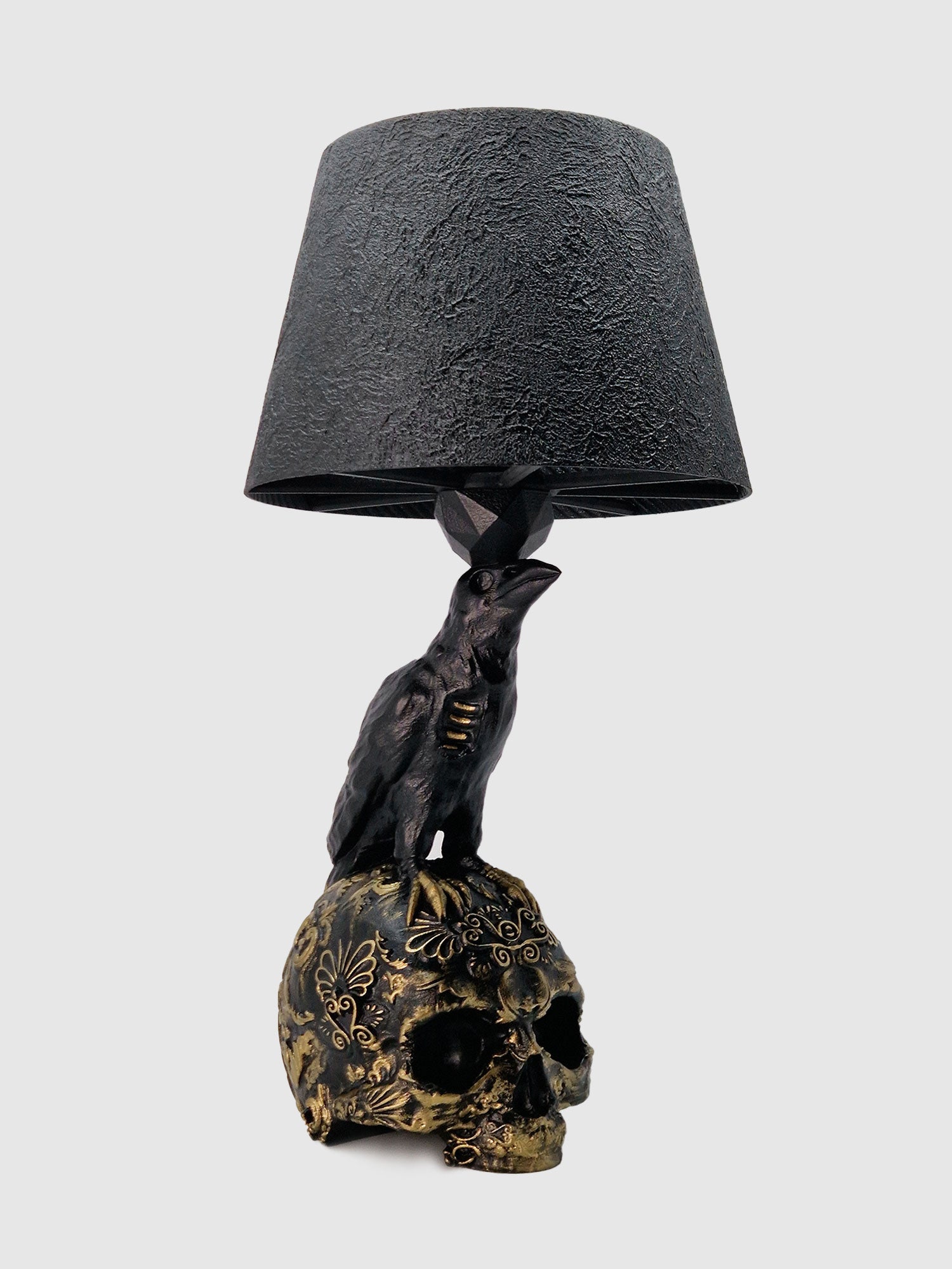 Side view of the Raven Skull lamp showing the intricate gold carvings and textured black lampshade created by Horror Romance.