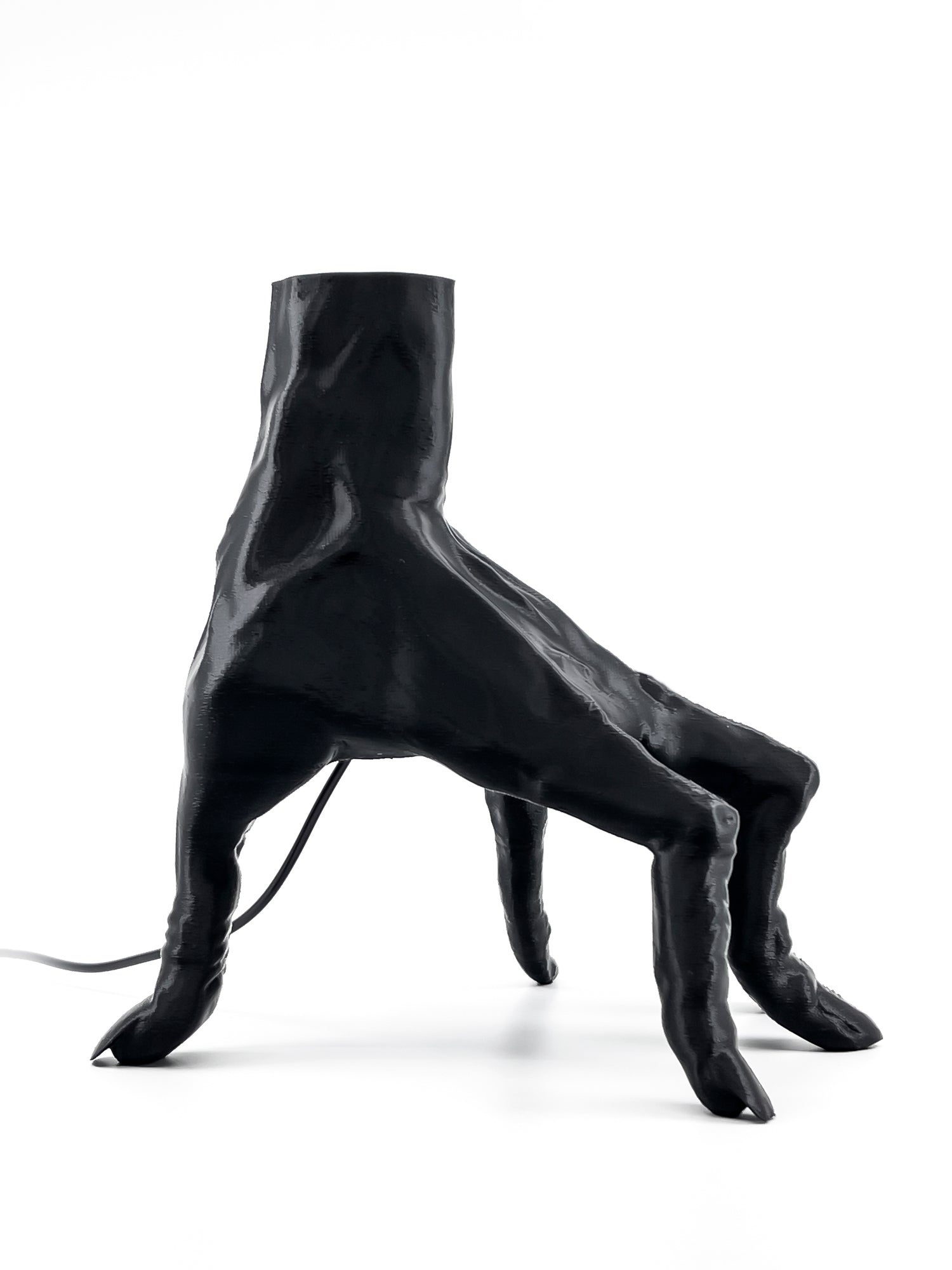 Back view of The Lost Hand tech dock showcasing the hollow wrist design for seamless charging cable management.