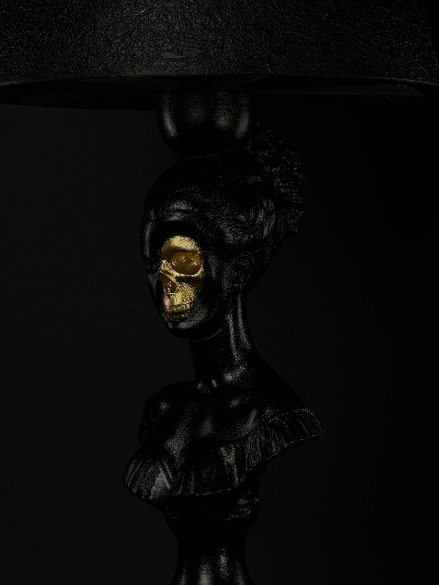Close-up of Hera’s exposed gold skull and hand-finished black classical bust
