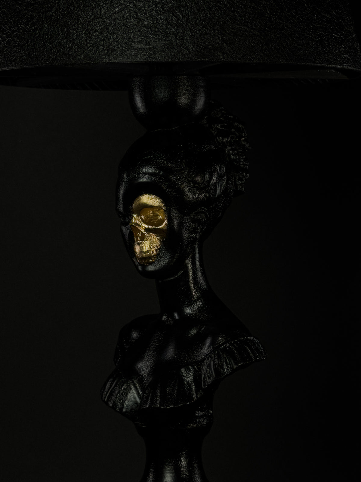 Close-up of Hera’s exposed gold skull and hand-finished black classical bust