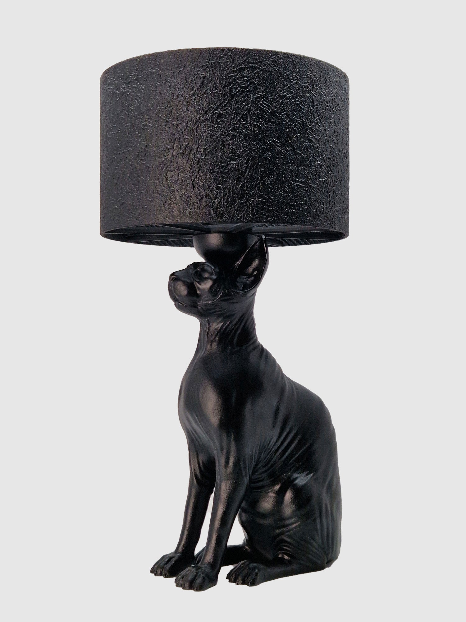 Close-up side view of the hairless cat lamp base featuring a smooth matte black finish and textured shade created by Horror Romance