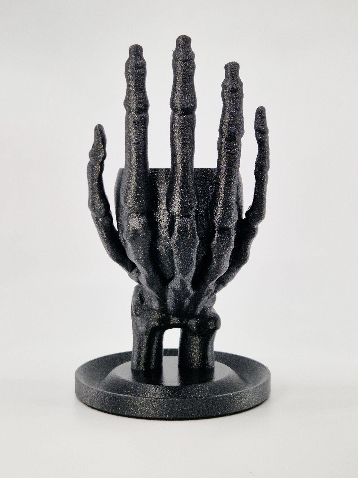 Back view of the skeleton hand ring holder showing the detailed anatomical knuckles and stable base.