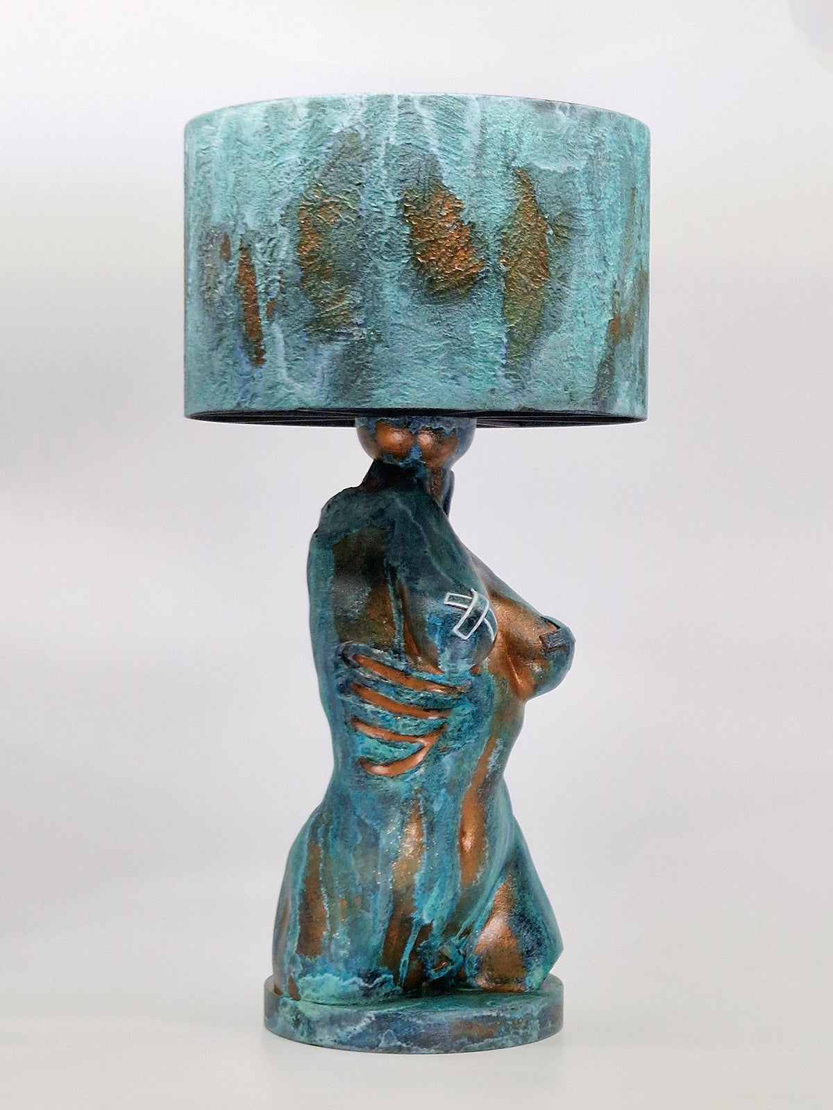 Side view of the Verdigris torso lamp showcasing the hand-painted aged metal effect and matching textured shade.