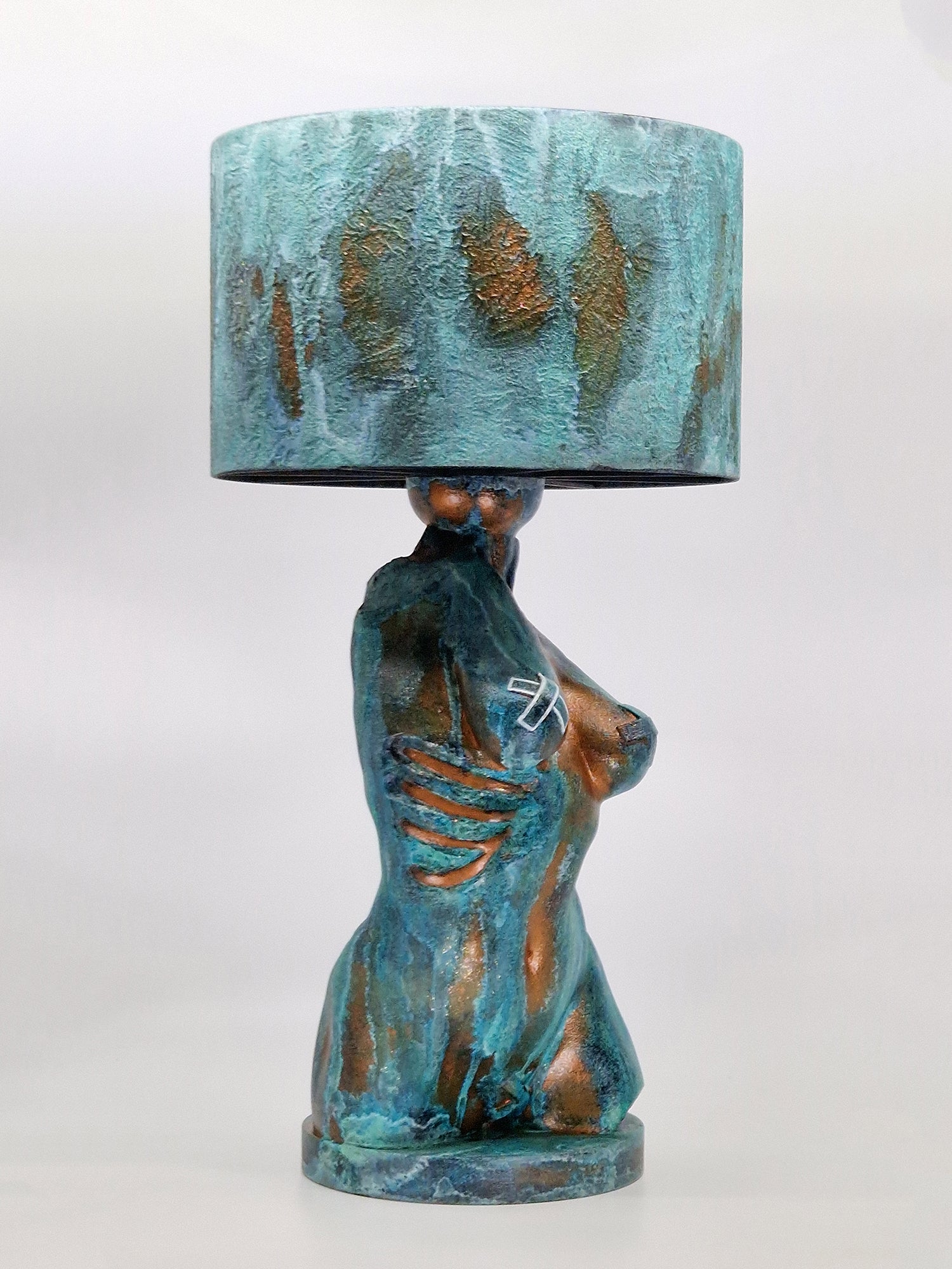 Side view of the Verdigris torso lamp showcasing the hand-painted aged metal effect and matching textured shade.
