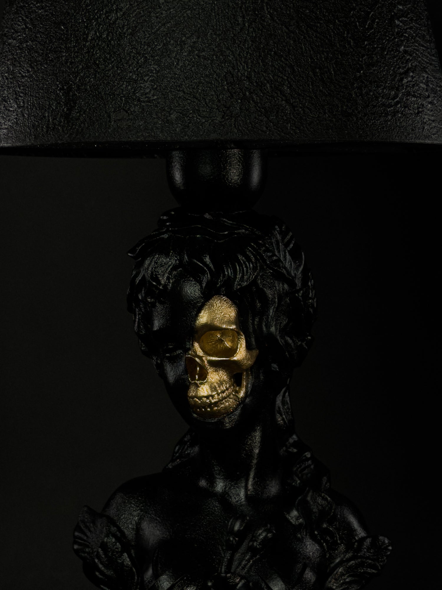 Detail view of Venus’s metallic-gold skull and hand-finished black mineral surface