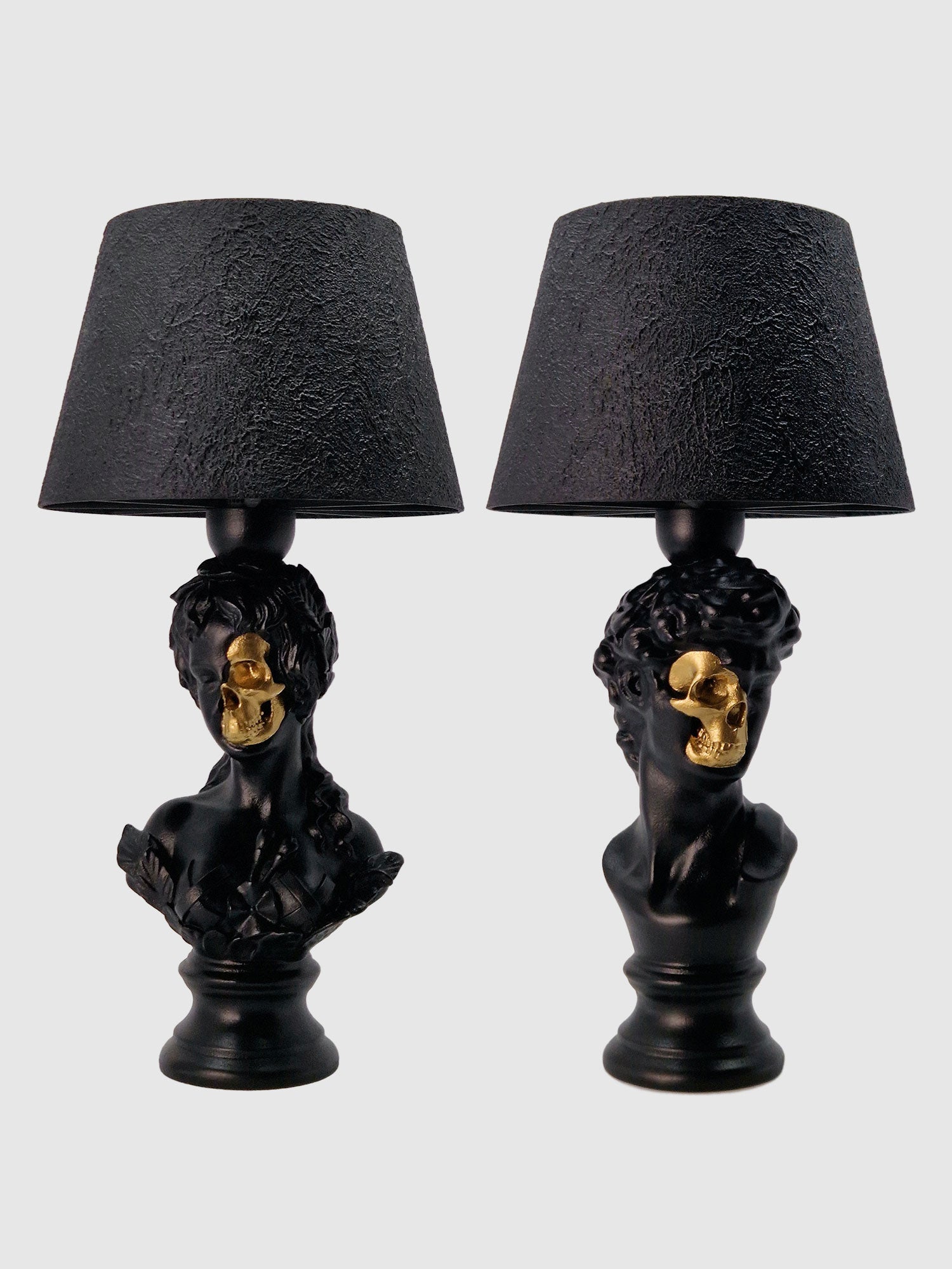 Front view of the Venus and David half-skull bust lamp set in matte black with gold-plated accents manufactured by Horror Romance.
