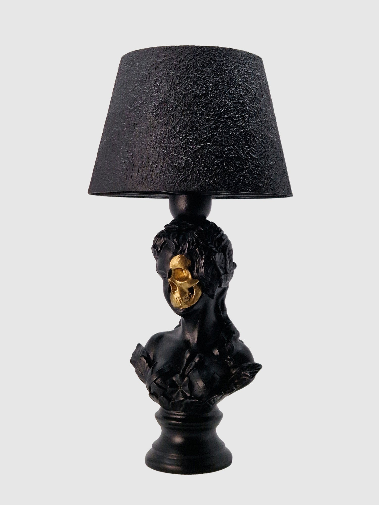 Angled front view of the Venus goddess bust lamp highlighting the anatomical gold-plated skull face by Horror Romance.