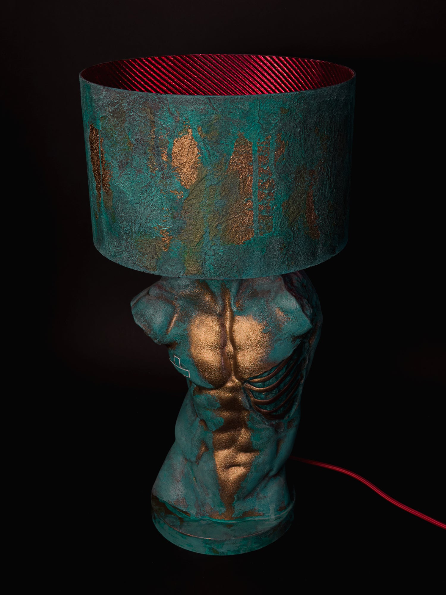 High-angle front view of Verdigris Body Adam showing the red shade lining, sculpted torso and red cable