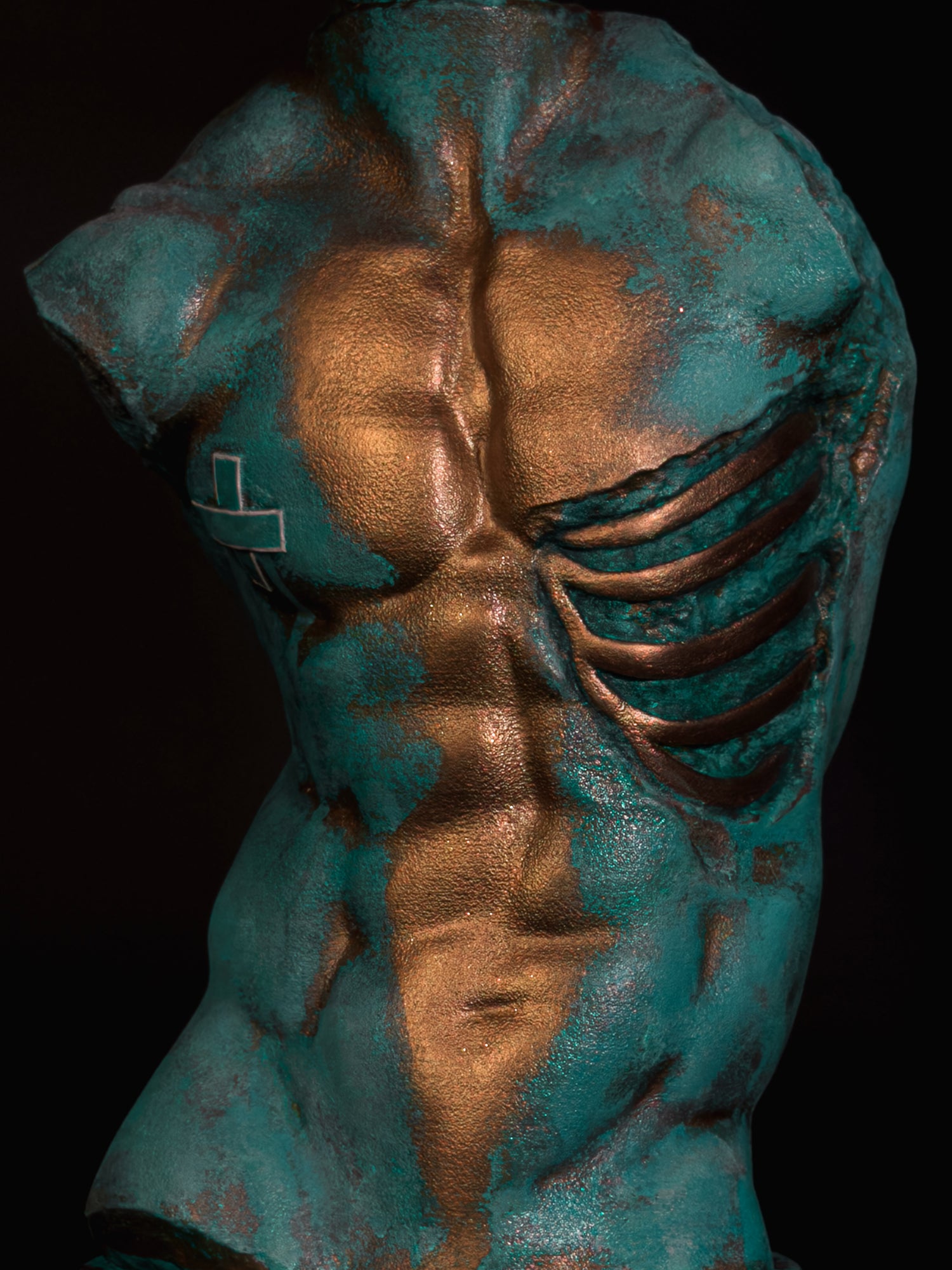 Close-up of Verdigris Body Adam showing copper highlights across the chest and abdomen beside exposed ribs