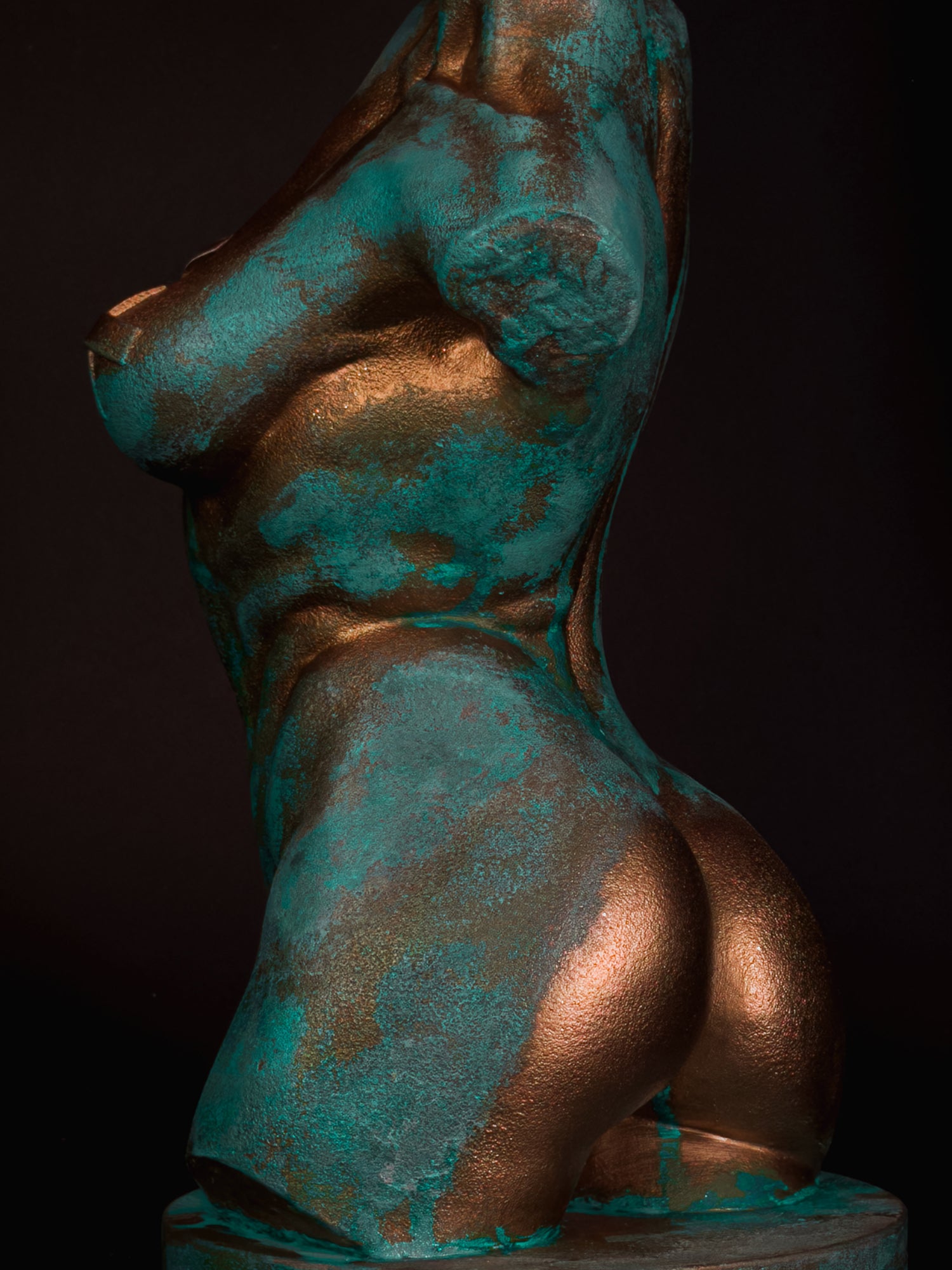 Close-up of the back and hip of Verdigris Body Eve showing turquoise oxidation and reflective copper
