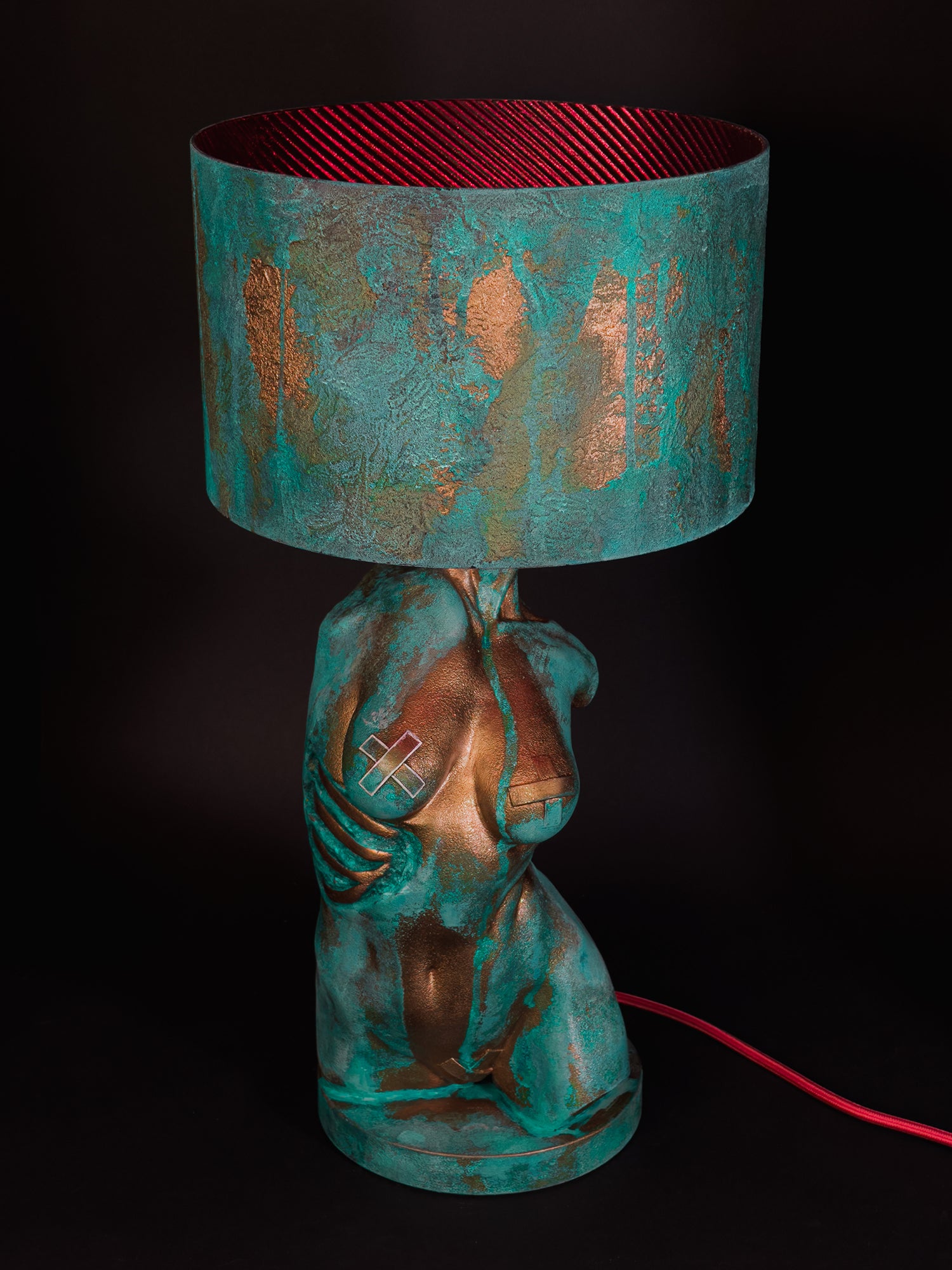 High-angle front view of Verdigris Body Eve showing the red shade lining and red cable