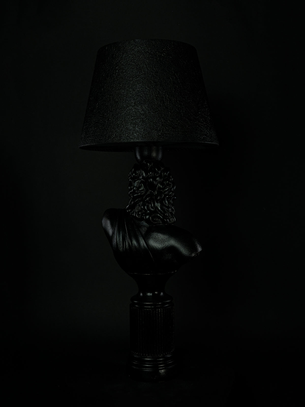 Back view of the satin-black Zeus classical bust lamp and fluted pedestal